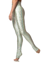 woman wearing long legging with mermaid pattern of mint colored sparkling fish scales on grey background