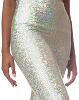 woman wearing sneaker length legging with mermaid pattern of mint colored sparkling fish scales on grey background