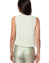 woman wearing tank top in mint green on grey background