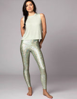 woman wearing tank top in mint green on grey background