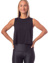 woman wearing tank top in black on grey background