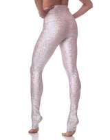 woman wearing long legging with mermaid pattern of pink colored sparkling fish scales on grey background