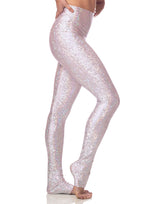 woman wearing long legging with mermaid pattern of pink colored sparkling fish scales on grey background