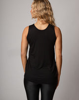 woman wearing tank top in black on grey background