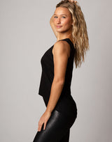 woman wearing tank top in black on grey background