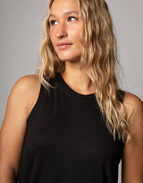 woman wearing tank top in black on grey background