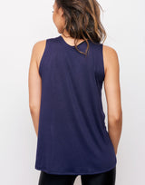 woman wearing tank top in navy on grey background