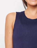 woman wearing tank top in navy on grey background