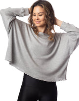 woman wearing oversized waffle knit long sleeve top in heather grey on grey background