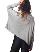 woman wearing oversized waffle knit long sleeve top in heather grey on grey background