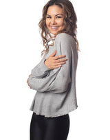 woman wearing oversized waffle knit long sleeve top in heather grey on grey background