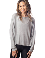 woman wearing oversized waffle knit long sleeve top in heather grey on grey background