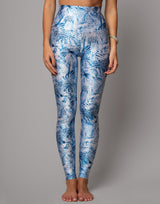 Blue floral leggings worn by a person on a gray background