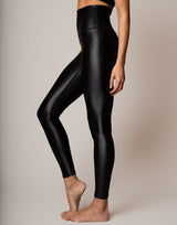 Black leggings worn by a person on a plain background