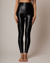 Black leggings worn by a person on a neutral background