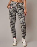 Camouflage jogger pants worn by a person on a plain background