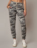 Camouflage jogger pants worn by a person on a plain background