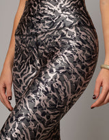 Patterned leggings worn by a person on a gray background