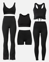 Set of black athletic wear including leggings, sports bras, and shorts on a white background