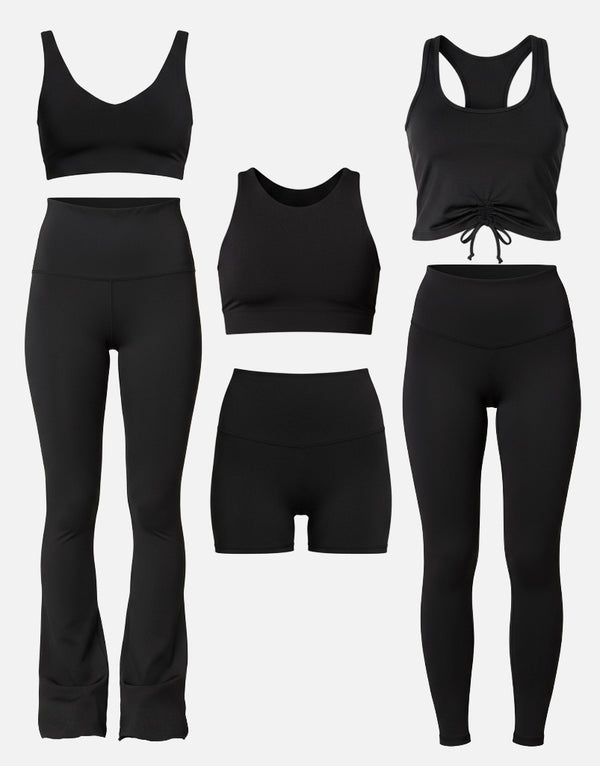 Set of black athletic wear including leggings, sports bras, and shorts on a white background