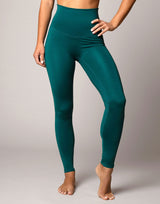 Teal leggings worn by a person on a plain background