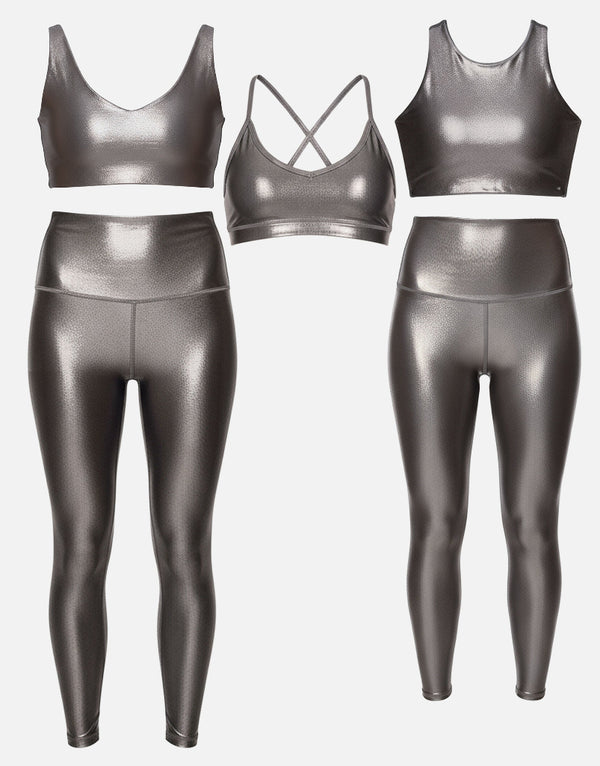 Metallic silver sports bra and leggings set on a light gray background