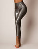 Shiny silver leggings worn by a person on a neutral background