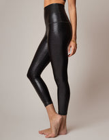 Black leggings worn by a person on a neutral background