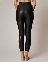 Black leggings worn by a person on a plain background