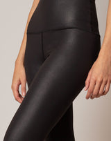 Black leggings worn by a person on a neutral background