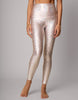 Person wearing sparkly silver leggings on a gray background