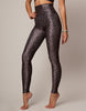 Person wearing leopard print leggings on a plain background