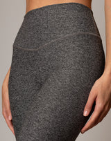 Close-up of dark gray leggings with a neutral background