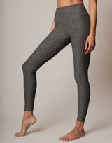 Gray leggings worn by a person on a plain background