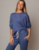 Woman wearing a blue outfit with a plain background
