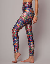 Colorful floral leggings worn by a person on a gray background